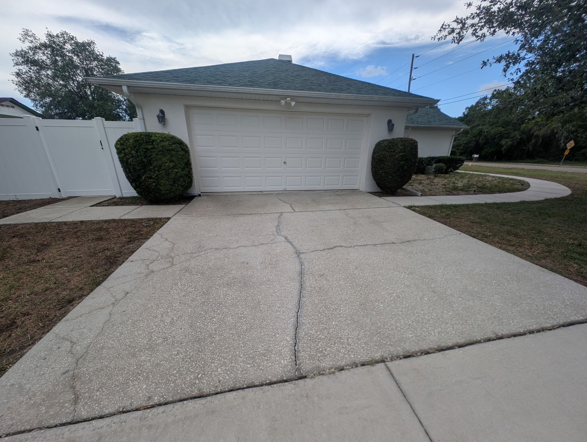 Same driveway after pressure washing — bright, clean concrete